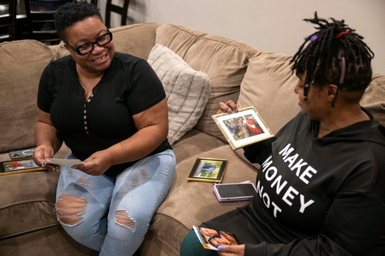 Reba Paul (L) and Stephanie Fairweather share memories of their late brother Denton Loudermill Jr. in Olathe, Kansas