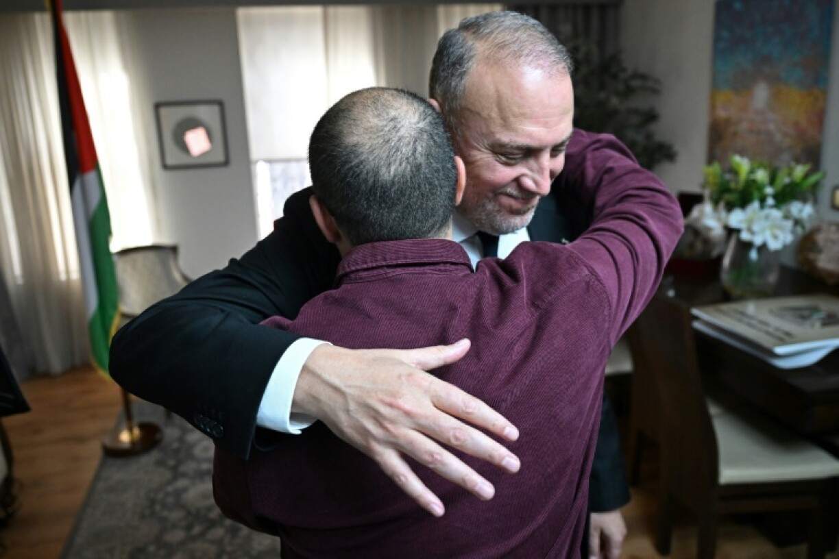 Husam Zomlot embraces a member of staff after Britain's Prime Minister Keir Starmer formally recognised a Palestinian state