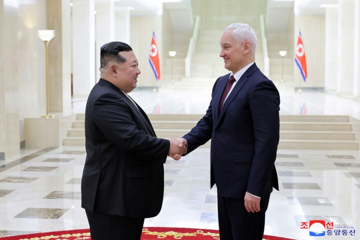 North Korean leader Kim Jong Un (L) greets Russian defence chief Andrei Belousov in Pyongyang