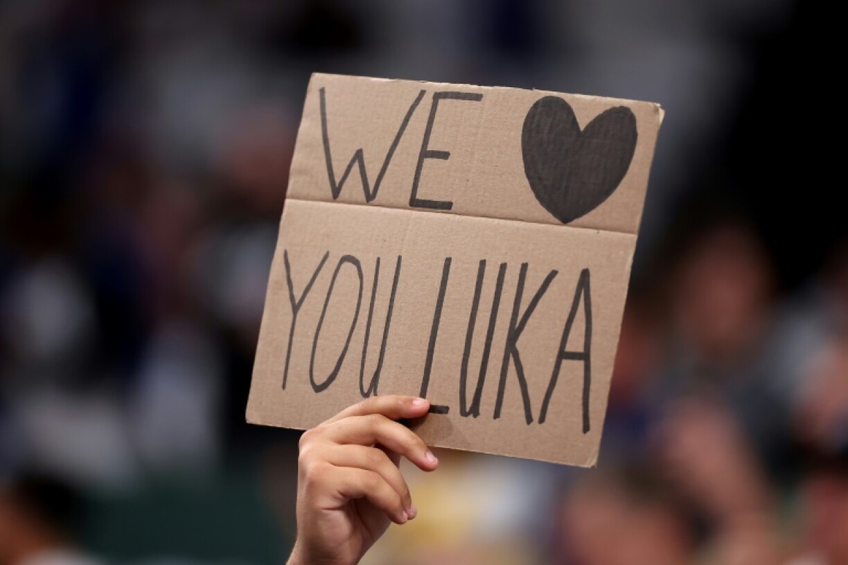 A Dallas fan holds a sign in tribute to Luka Doncic on his first return to face the club following his departure to the Los Angeles Lakers