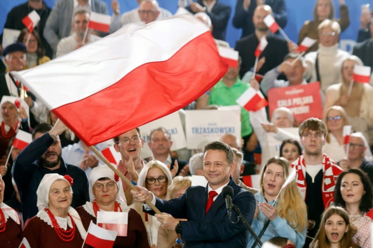 Rafal Trzaskowski, centrist mayor of Warsaw, waves a Polish flag during a campaign rally ahead of the June 1, 2025 presidential runoff in Poland. Trzaskowski faces conservative historian Karol Nawrocki, the Law and Justice (PiS) candidate, in a closely contested race.