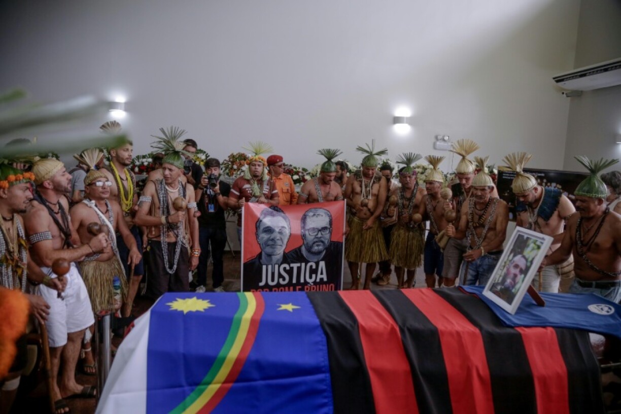 Xukuru's Indigenous people sing a sacred prayer in honor of the Brazilian Indigenous expert Bruno Pereira next to his coffin during his funeral after his murder in June 2022