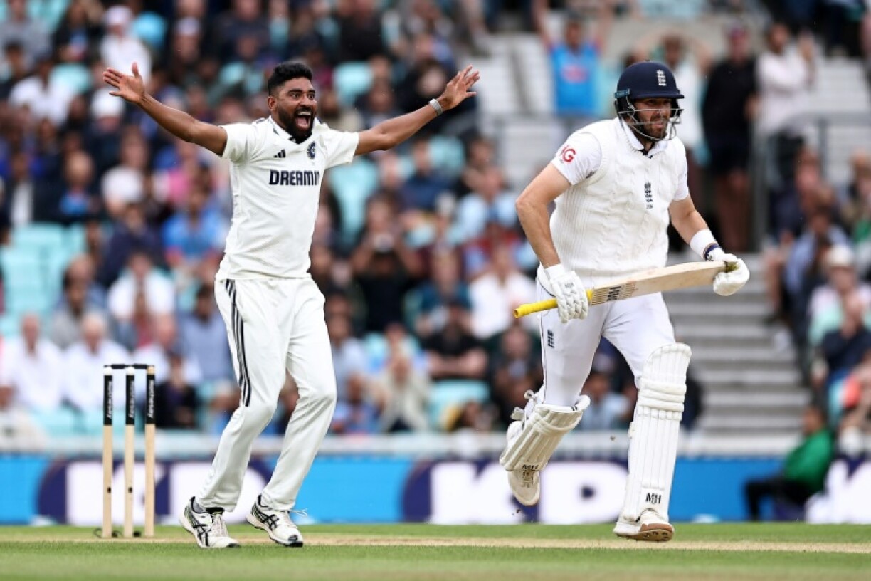 Mohammed Siraj (L) celebrates dismissing England's Jamie Overton (R) during India's six-run win in the fifth Test at the Oval