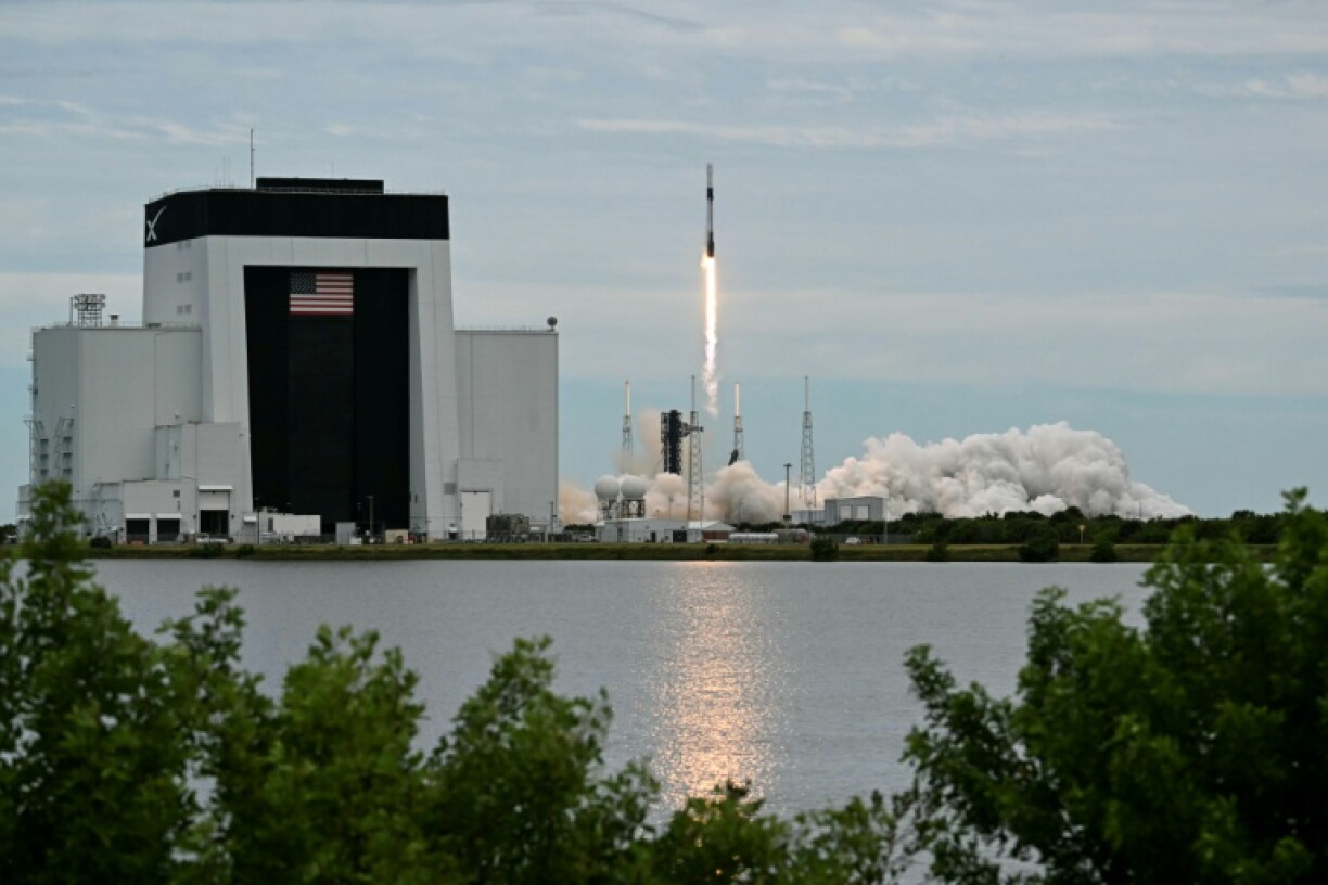 A SpaceX Falcon 9 rocket topped with the Dragon capsule lifts off for the International Space Station from Cape Canaveral, Florida