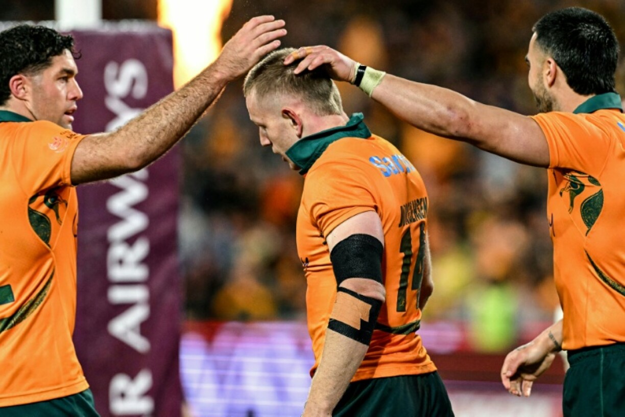 Australia's Max Jorgensen is congratulated by teammates after scoring a try in the third Test