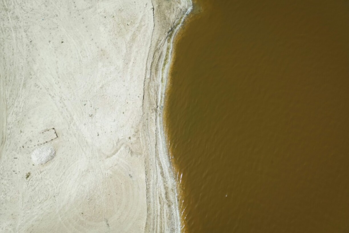 Separated from the Atlantic by a narrow dune, the shallow lake is densely laden with salt