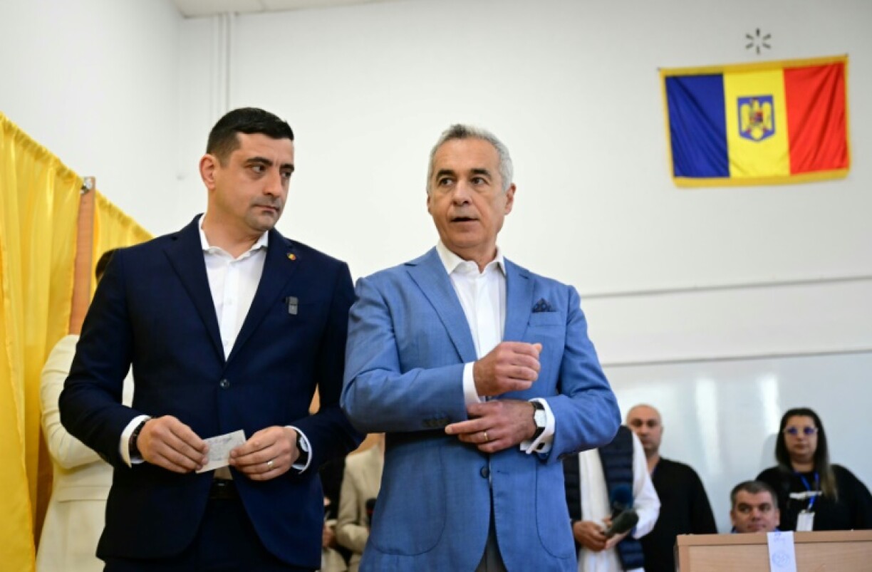 Former presidential candidate Calin Georgescu cast his ballot alongside far-right leader George Simion