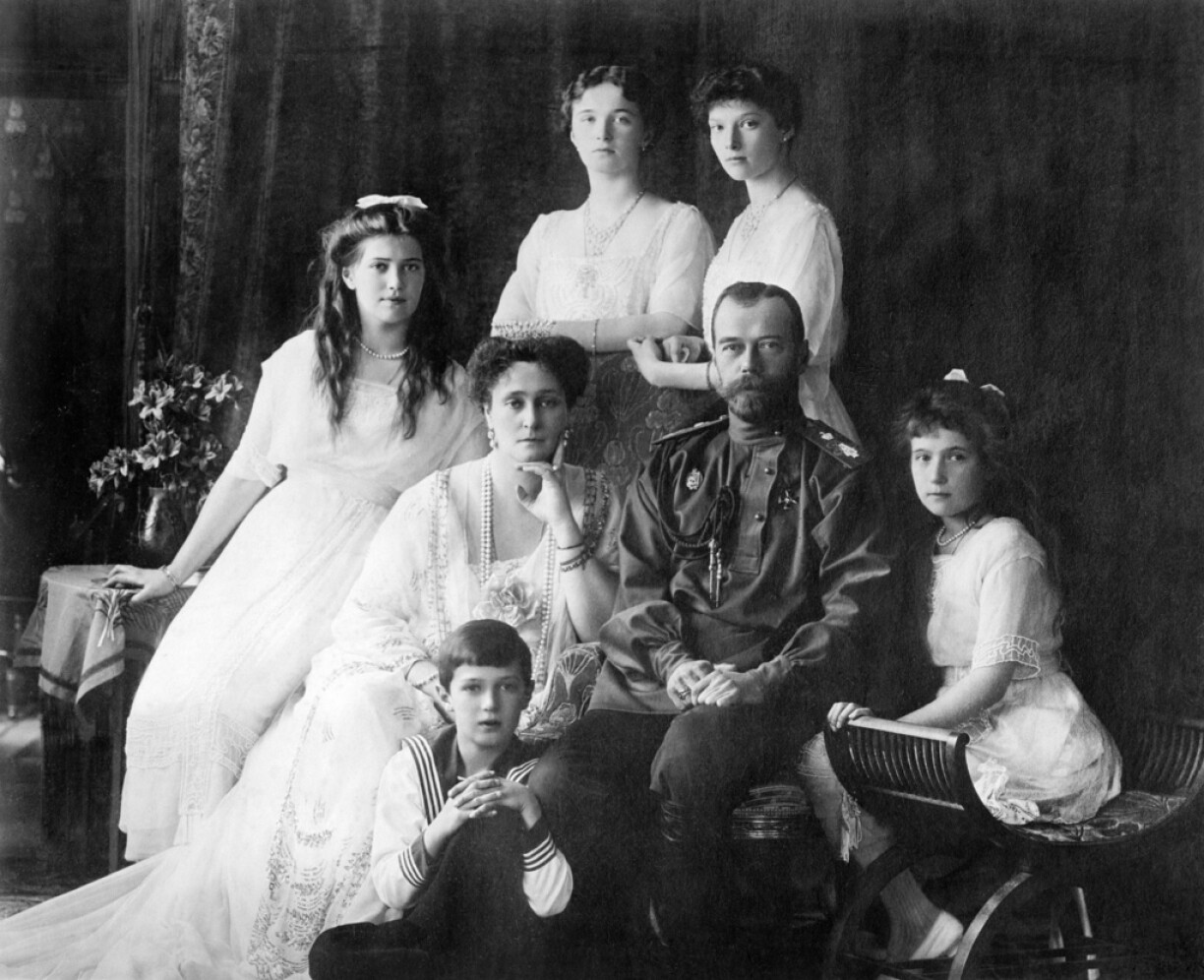 Left to right: Marie, Empress Alexandra, Tsar Nicholas II, Anastasia, Alexei (front), and standing (left to right), Olga and Tatiana.
