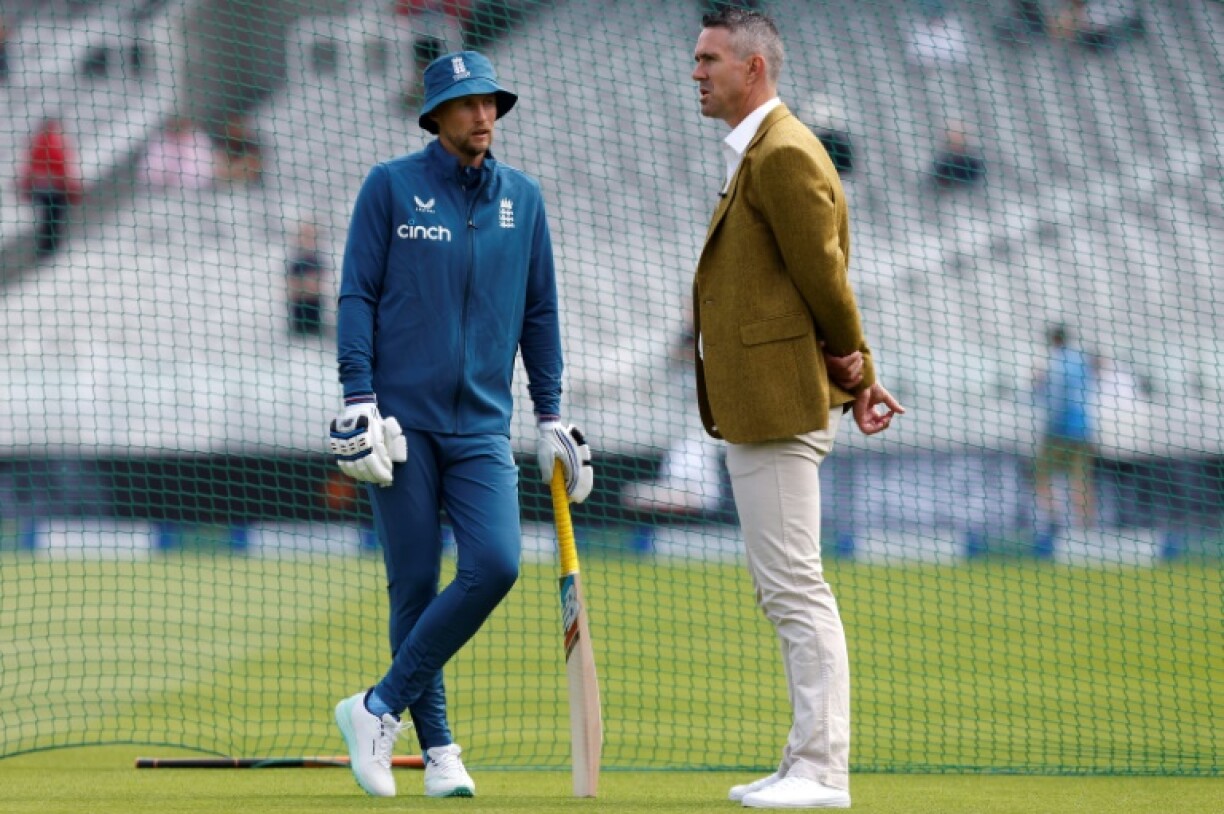 England's Joe Root (L) speaks to former England player Kevin Pietersen at Lord's