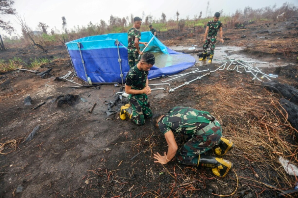 Indonesian soldiers tasked with fighting forest and land fires also celebrated the rains in Banjar Baru, South Kalimantan