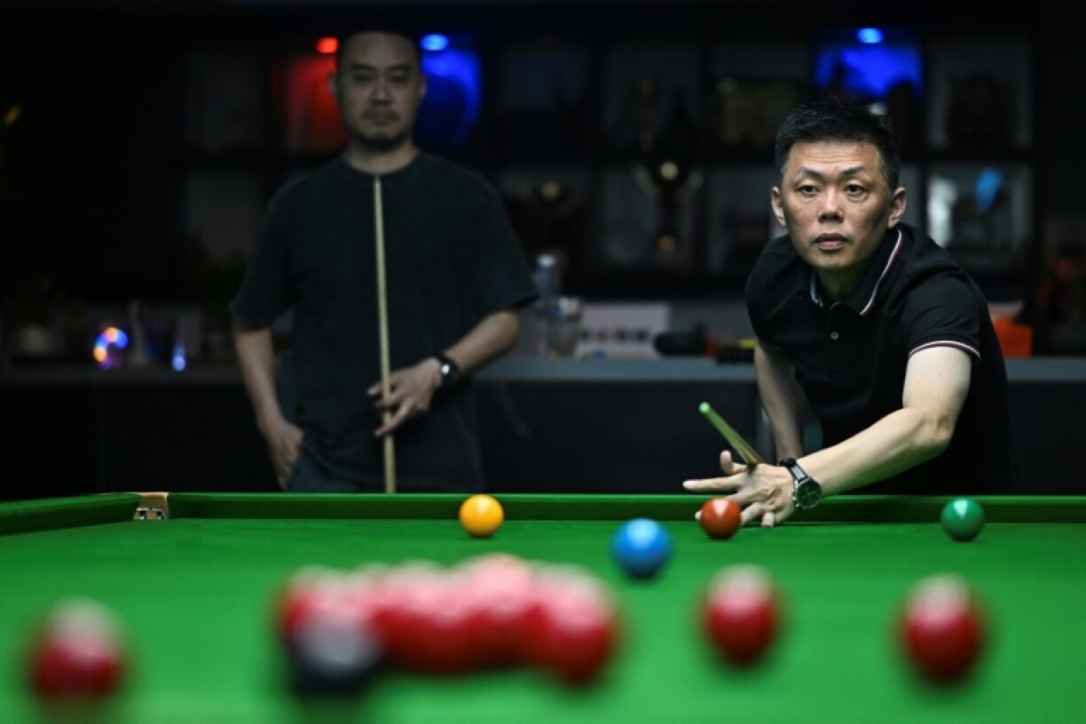A man plays snooker at a club in Beijing
