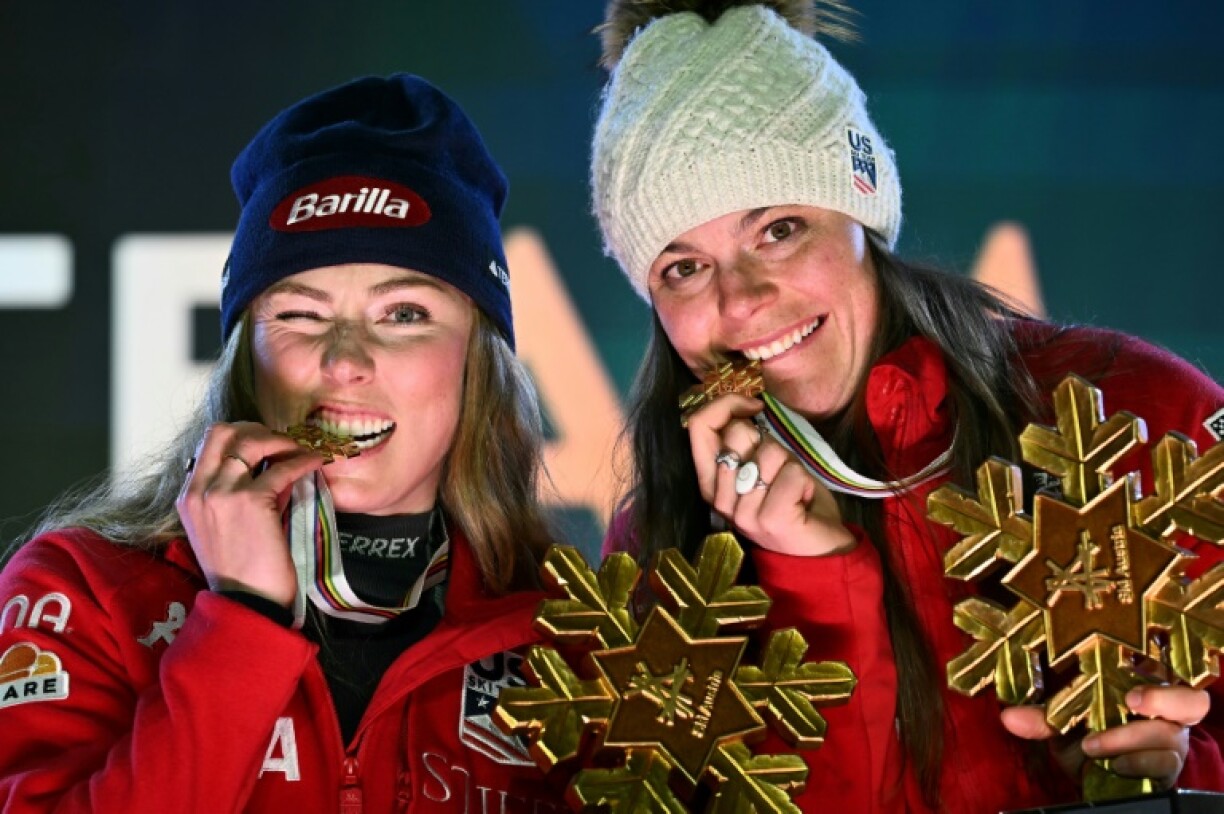 Mikaela Shiffrin (L) and US teammate Breezy Johnson celebrate after winning the team combined gold