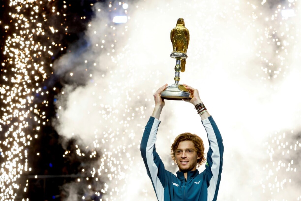 Andrey Rublev brandishes the trophy after winning the Qatar Open