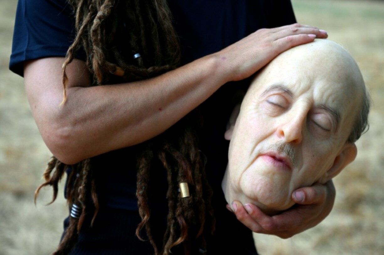Spanish metal artist Berta Canals holds a hyper-realistic replica of dictator Francisco Franco's head before the performance