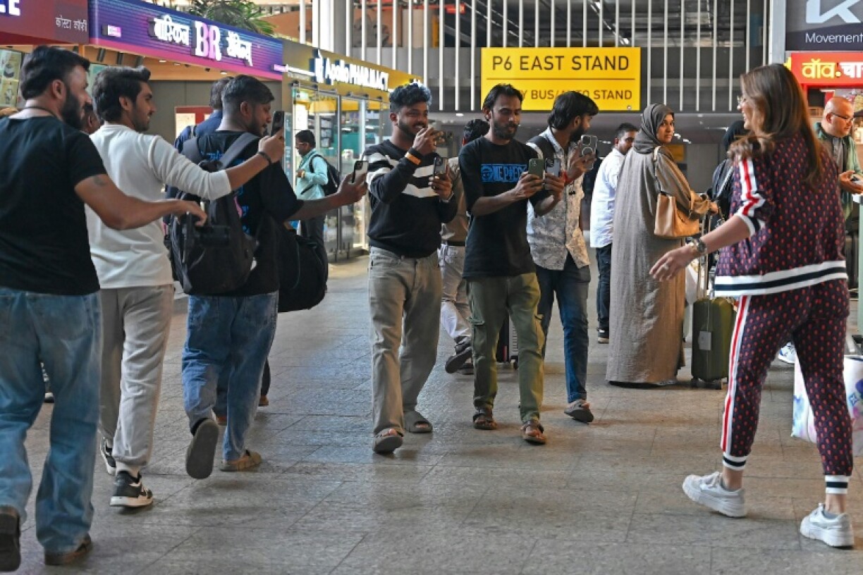 Paparazzi, here taking pictures and videos of Indian actress Akanksha Puri (R), have developed an increasingly symbiotic relationship with Bollywood
