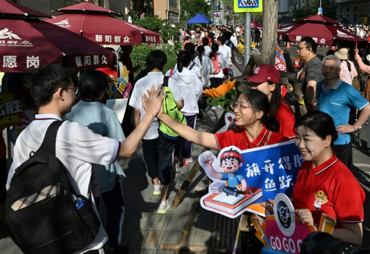 While teachers and staff offered students their support, holding up signs of encouragement, some test takers, dressed in school uniforms, appeared panicked