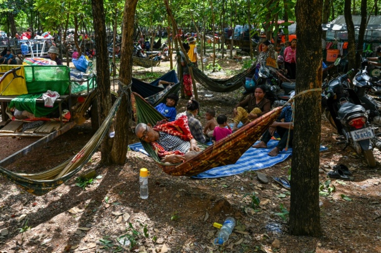 People who fled their homes near the Thai border rest on the grounds of a pagoda in Oddar Meanchey province in Cambodia