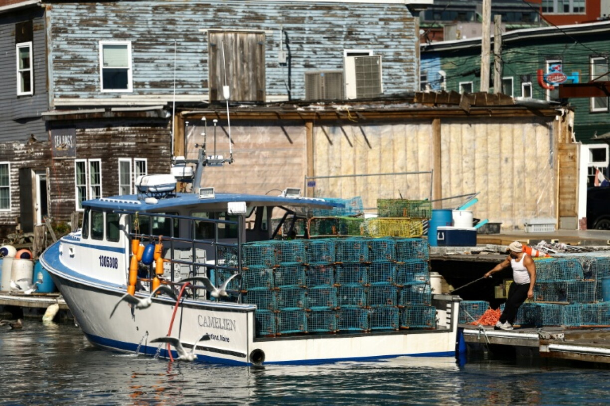 Maine's lobster operations -- trap hauling, boat transport, food processing and restaurant sales -- comprise a billion-dollar industry that has come under threat from high fuel prices, shifting tariffs and climate change Lobstermen arrive in the harbor after a morning at sea in Portland, Maine on October 12, 2026.