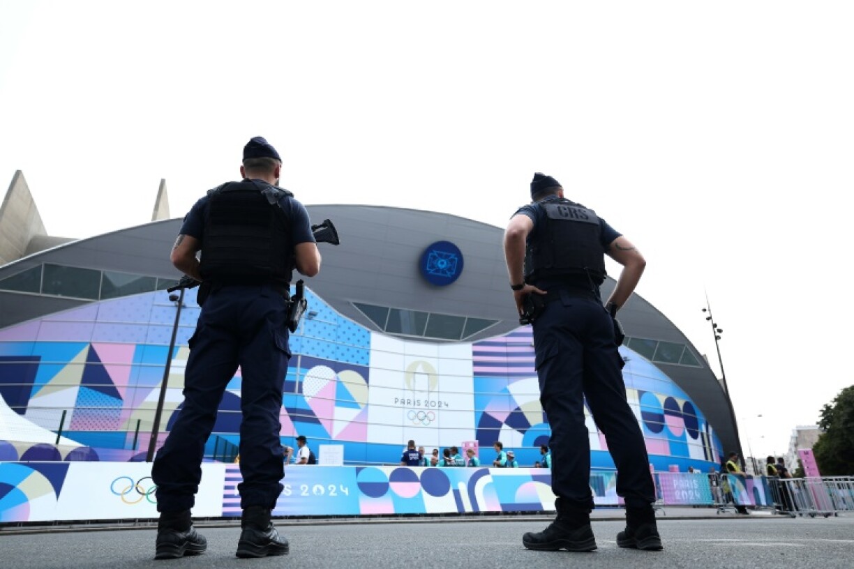 French riot police stand guard near the Parc des Princes ahead of an Olympic football match in July
