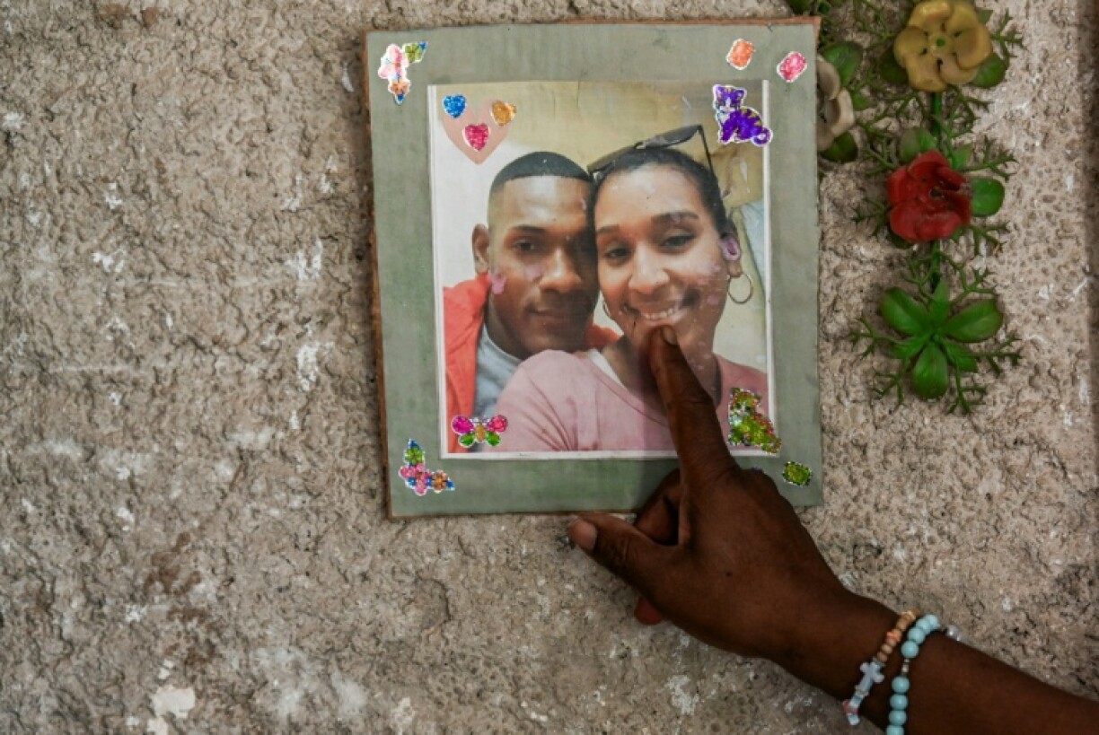 Osmara Garcia Mesa points at a picture of her son Jonathan Jesus Alvarez Garcia and his wife Noralvis Alvarez Flores who disappeared in January 2023 on a handmade migrant boat somewhere between Cuba and South Florida