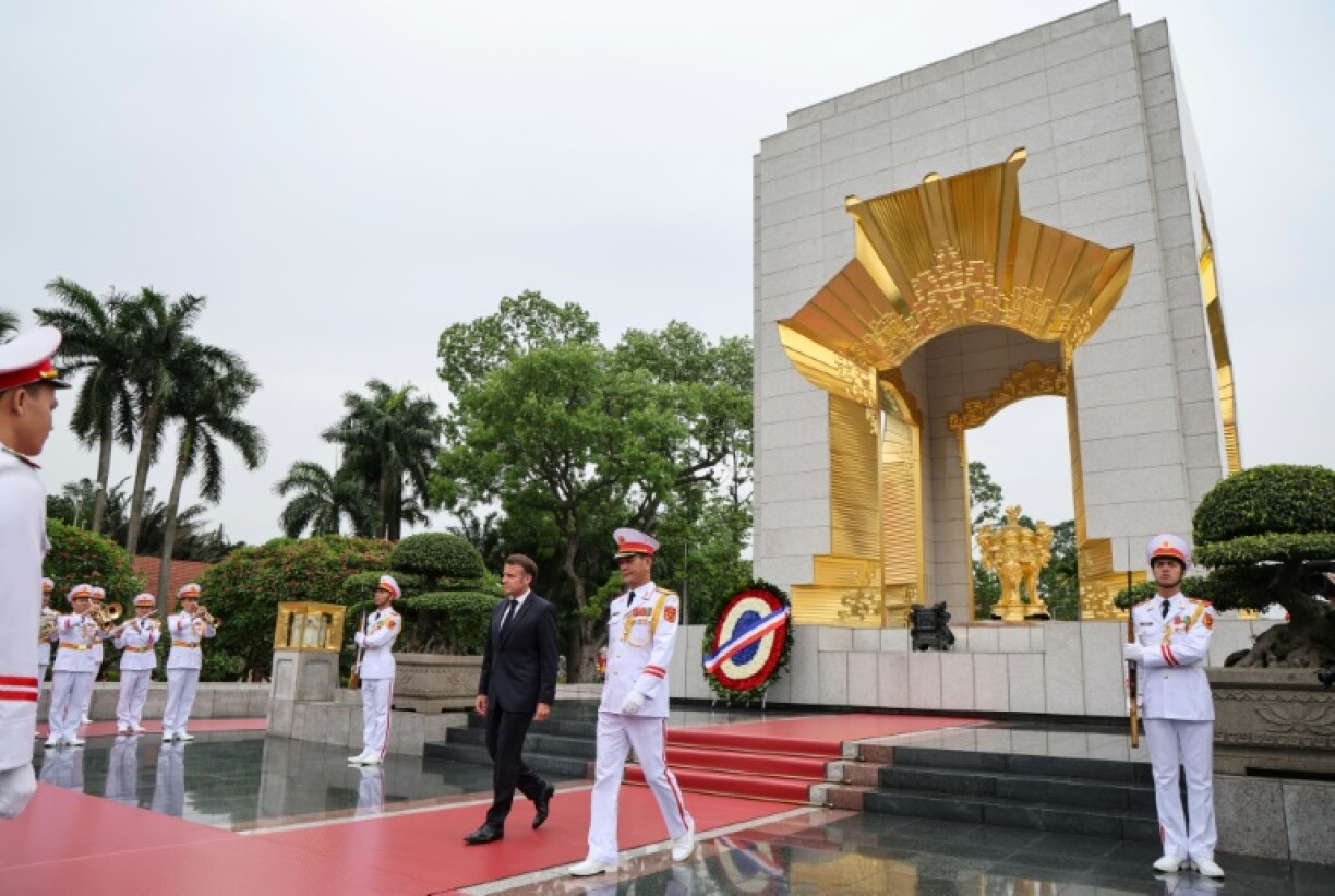 The French president paid tribute at a Hanoi war memorial to those who fought against French colonial occupation ahead of talks with Vietnamese leaders