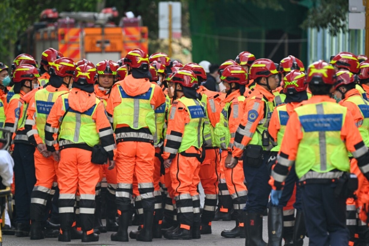 Fire department rescue teams gather after a blaze swept through several apartment blocks at the Wang Fuk Court residential estate in Hong Kong's Tai Po district