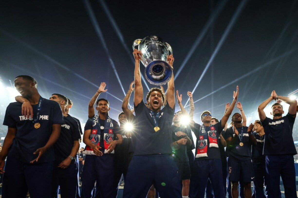 Paris Saint-Germain's captain Marquinhos showed off the Champions League trophy at the club's Parc des Princes stadium