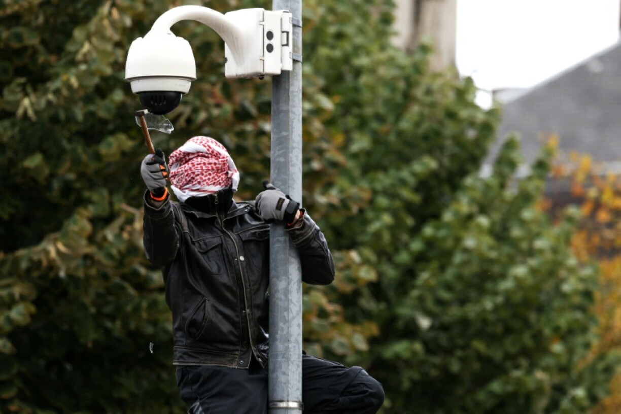 A protester seen vandalising a security camera in Strasbourg