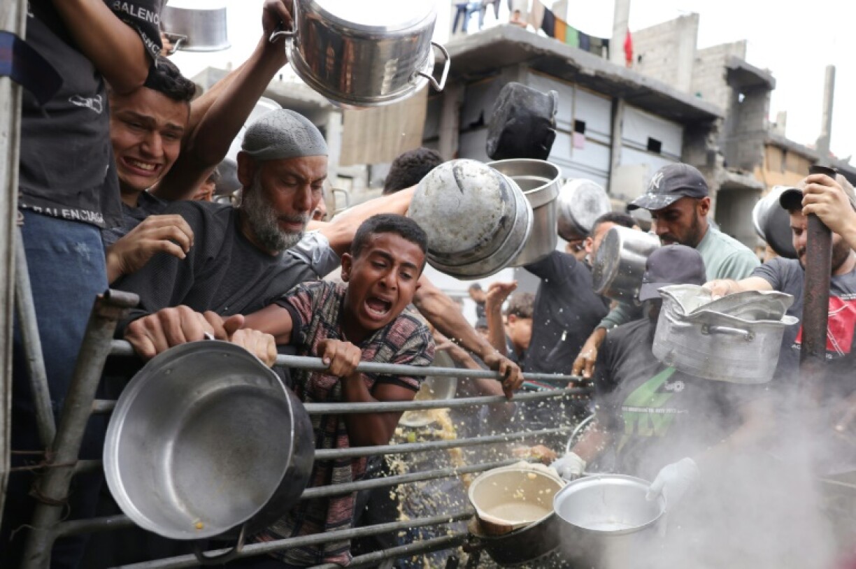 Palestinians struggle to get their food rations at a distribution centre in the northern Gaza Strip