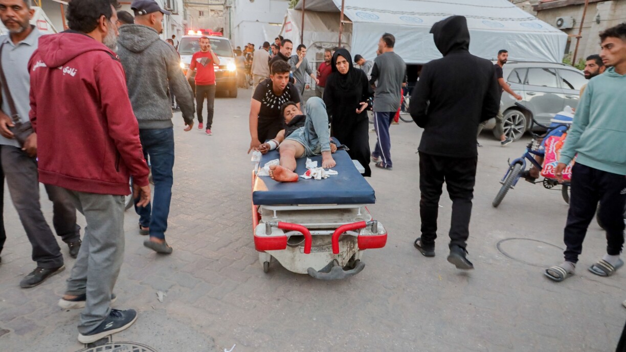 Medical personnel and residents gather near Al-Sahaba Street in Gaza City as victims are attended to on 29 October 2024.