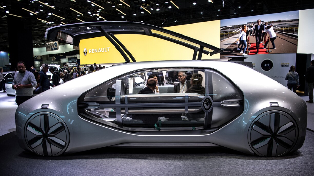 Visitors sit inside a Renault EZ-GO autonomous electric concept car presented at the Paris Motor Show on October 4, 2018 in Paris.