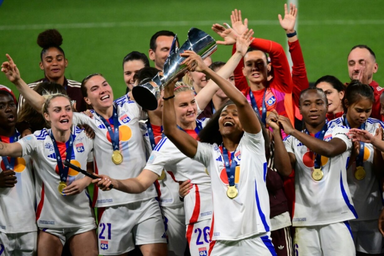Lyon defender Wendie Renard holds aloft the French first division trophy