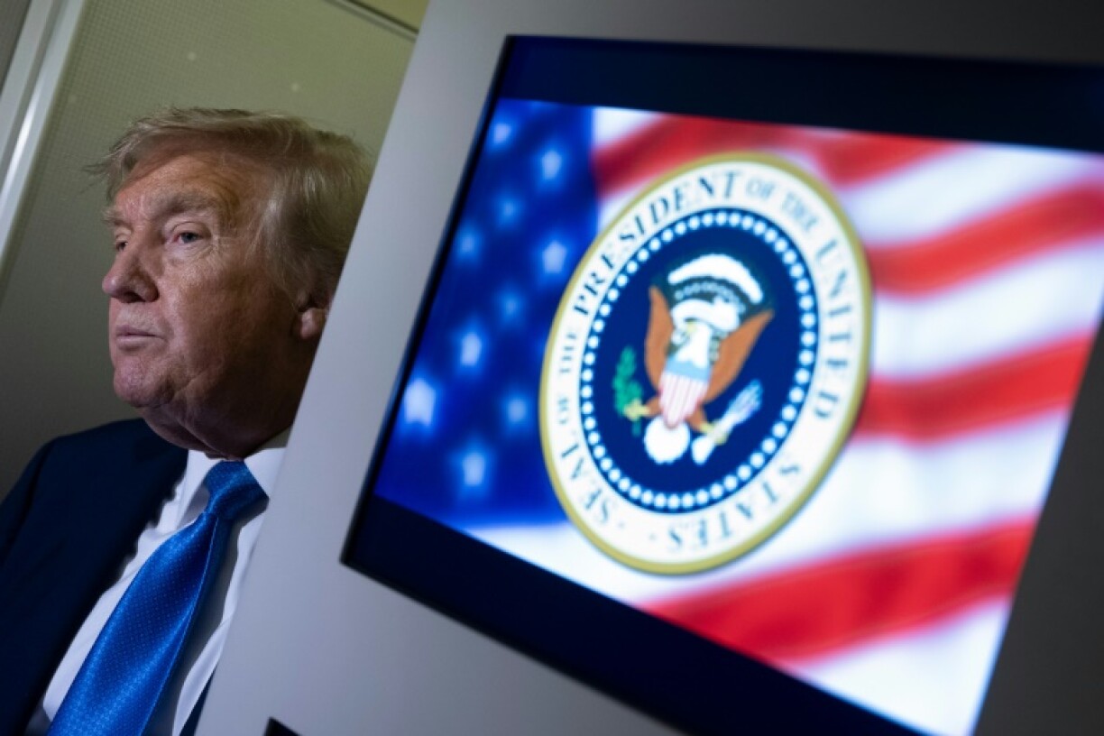 US President Donald Trump speaks to reporters about the G7 Summit aboard Air Force One while travelling back to Washington from Canada