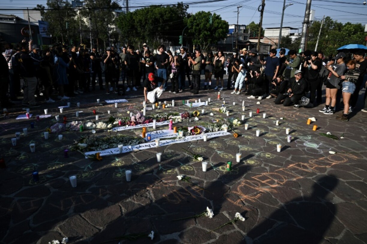 People held a vigil for two photographers killed at a music festival in Mexico City when a decorative structure collapsed