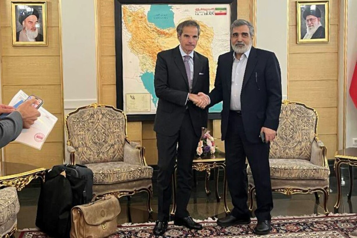 An Iranian Atomic Energy Organization picture shows IAEA chief Rafael Grossi (L) with IAEO spokesman Behrouz Kamalvandi in Tehran