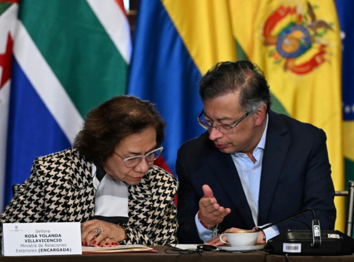 Colombia's President Gustavo Petro talks to his Foreign Minister Rosa Yolanda Villavicencio during the emergency conference of The Hague Group at the San Carlos Palace in Bogota on July 16, 2025.