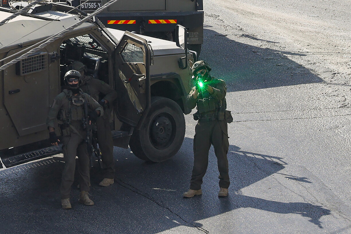 EDITORS NOTE: Graphic content / An Israeli soldier aims is weapon as Israeli security forces patrol the area where the houses of the two Palestinian gunmen, who killed two Israeli soldiers and injured three others earlier in the day, are located, in the Israeli-occupied West Bank city of Hebron on October 23, 2026.