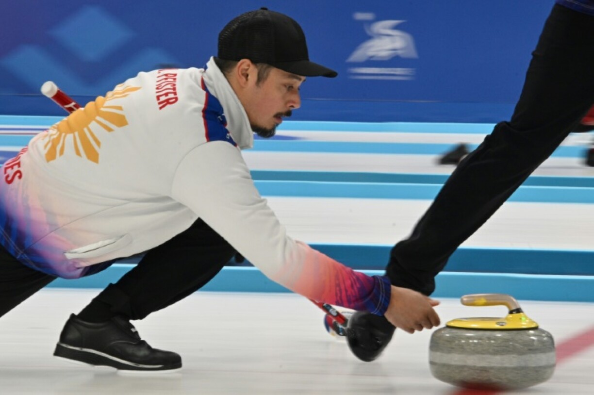 Marc Pfister releases a stone for the Philippines curlers in Harbin