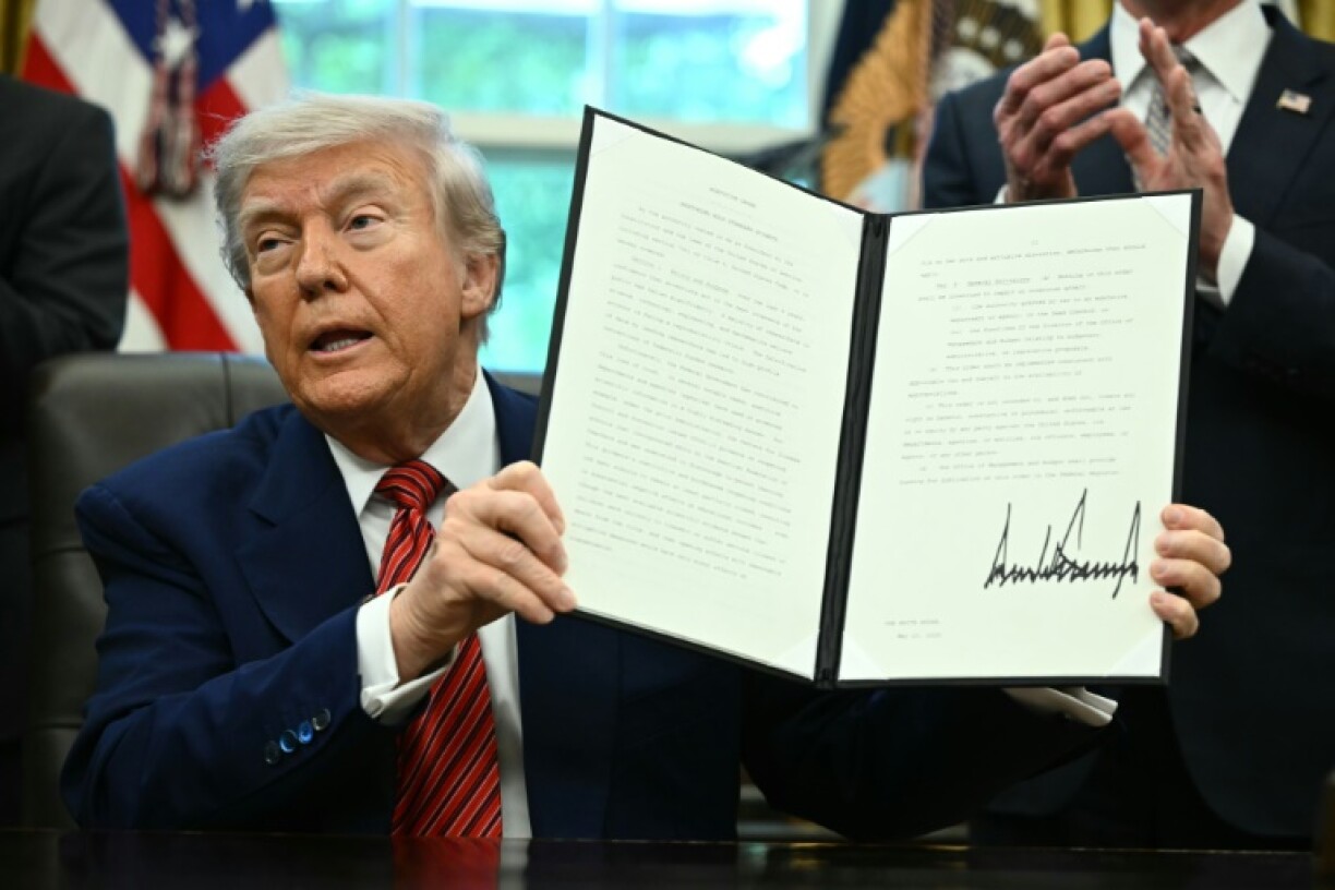 US President Donald Trump signs executive orders in the Oval Office of the White House in Washington, DC, on May 23, 2025.