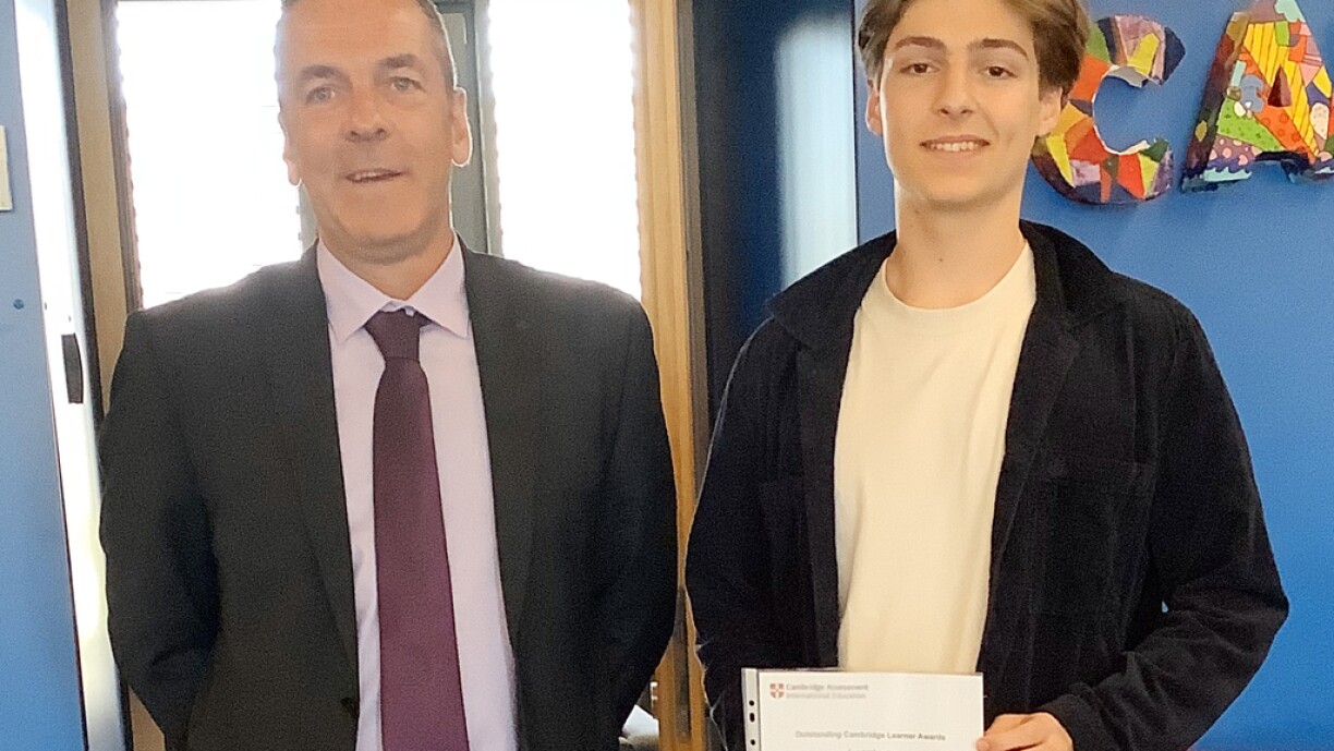 St George’s Secondary Head Teacher Mark Fleet congratulates former student Lieuwe Troelstra on receiving the Cambridge Top in the World Award for economics.