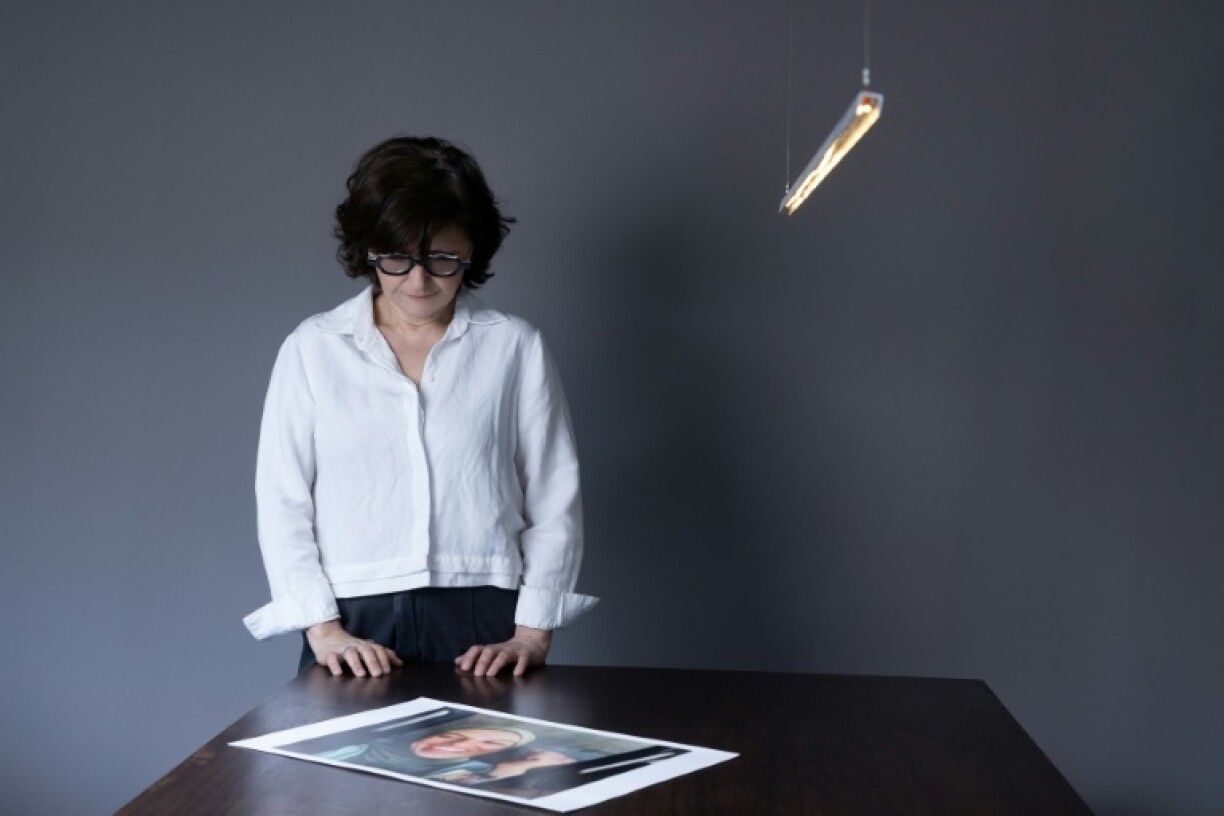 Iranian filmmaker and activist Sepideh Farsi looks at a portrait of the Palestinian photographer Fatima Hassouna, who was killed in the bombing of her house in the Gaza Strip