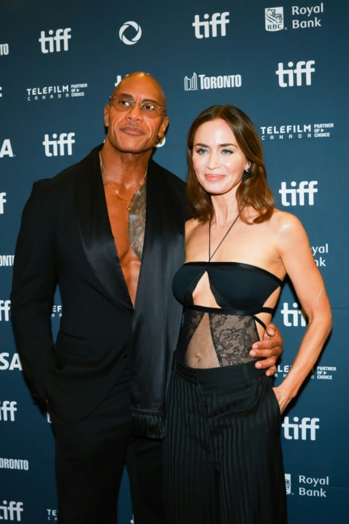 US actor Dwayne Johnson (L) and US-British actress Emily Blunt attend the premiere of