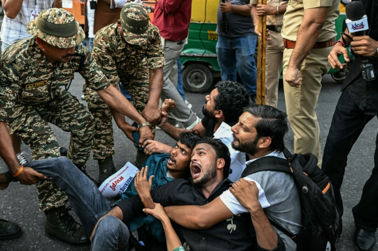 Indian security personnel detain demonstrators in New Delhi