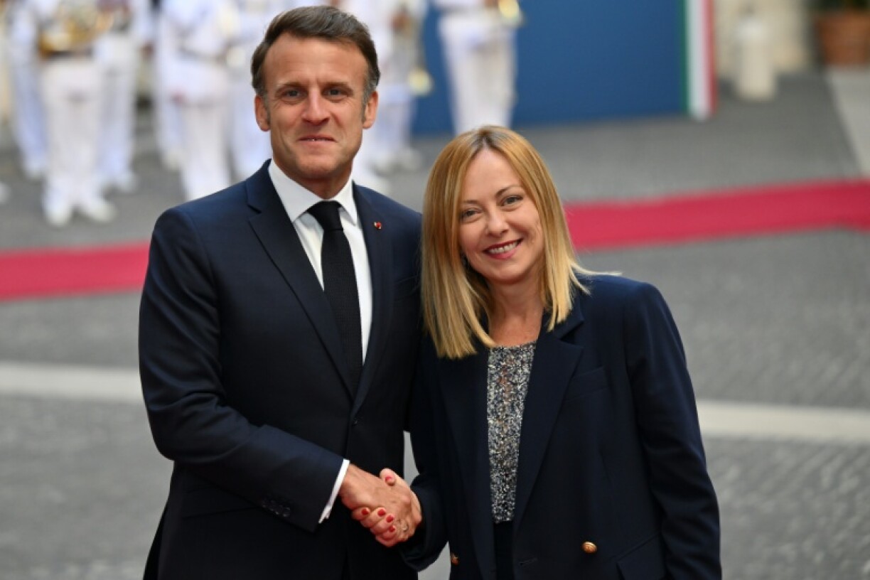 Italy’s Prime Minister Giorgia Meloni (R) shakes hands with France's President Emmanuel Macron in Rome