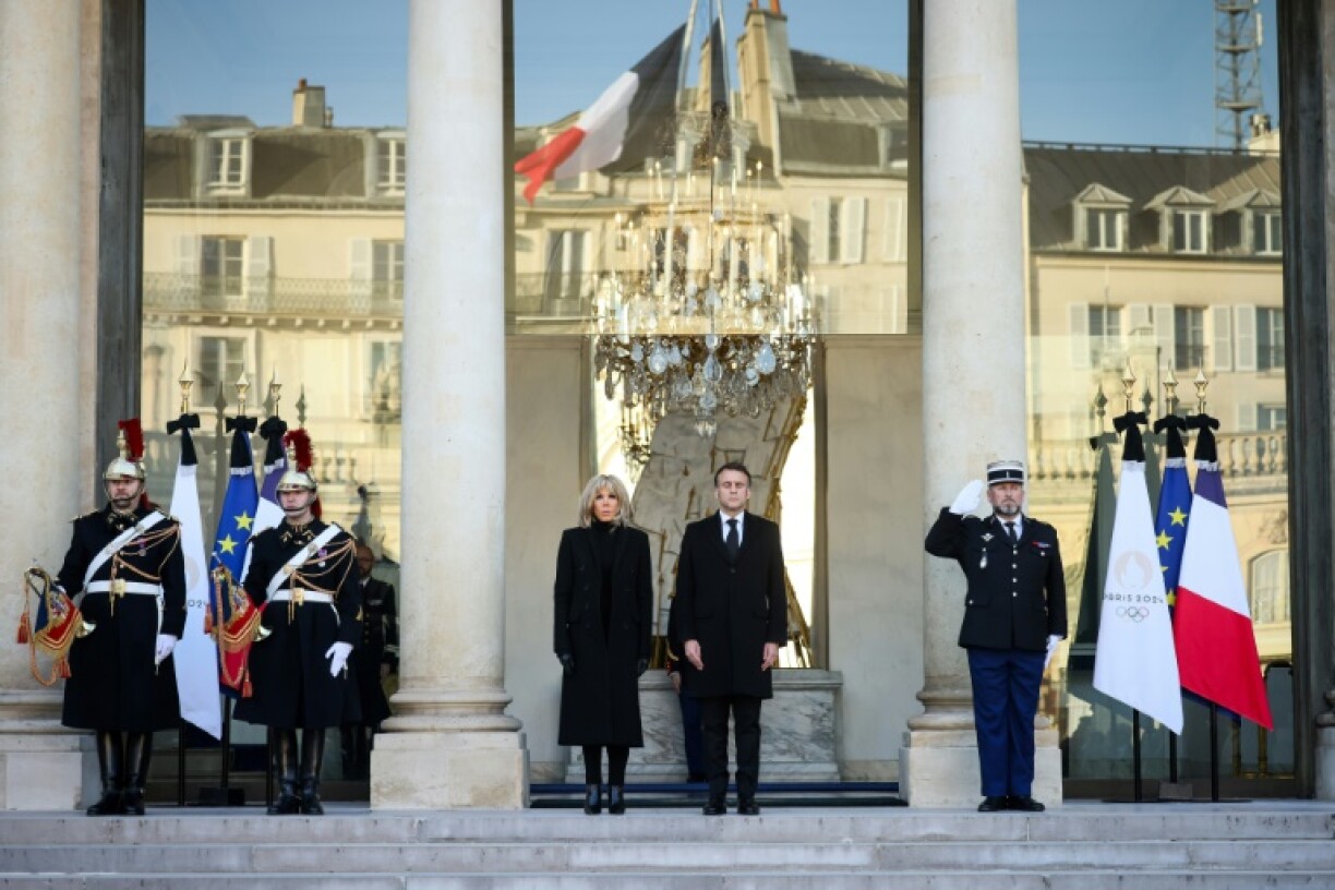 French President Emmanuel Macron and his wife, Brigitte, observe a minute of silence for the victims of cyclone-hit Mayotte