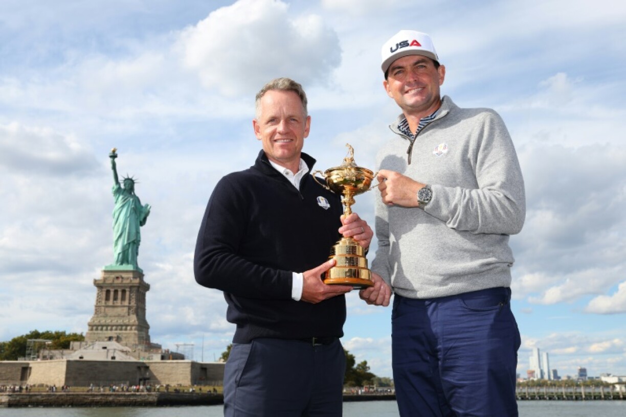 Europe team captain Luke Donald of England, left, and USA captain Keegan Bradley, right, hold the trophy for the Ryder Cup, with the PGA of America saying it will give away 3,000 tickets for the event in surprise events in the New York area