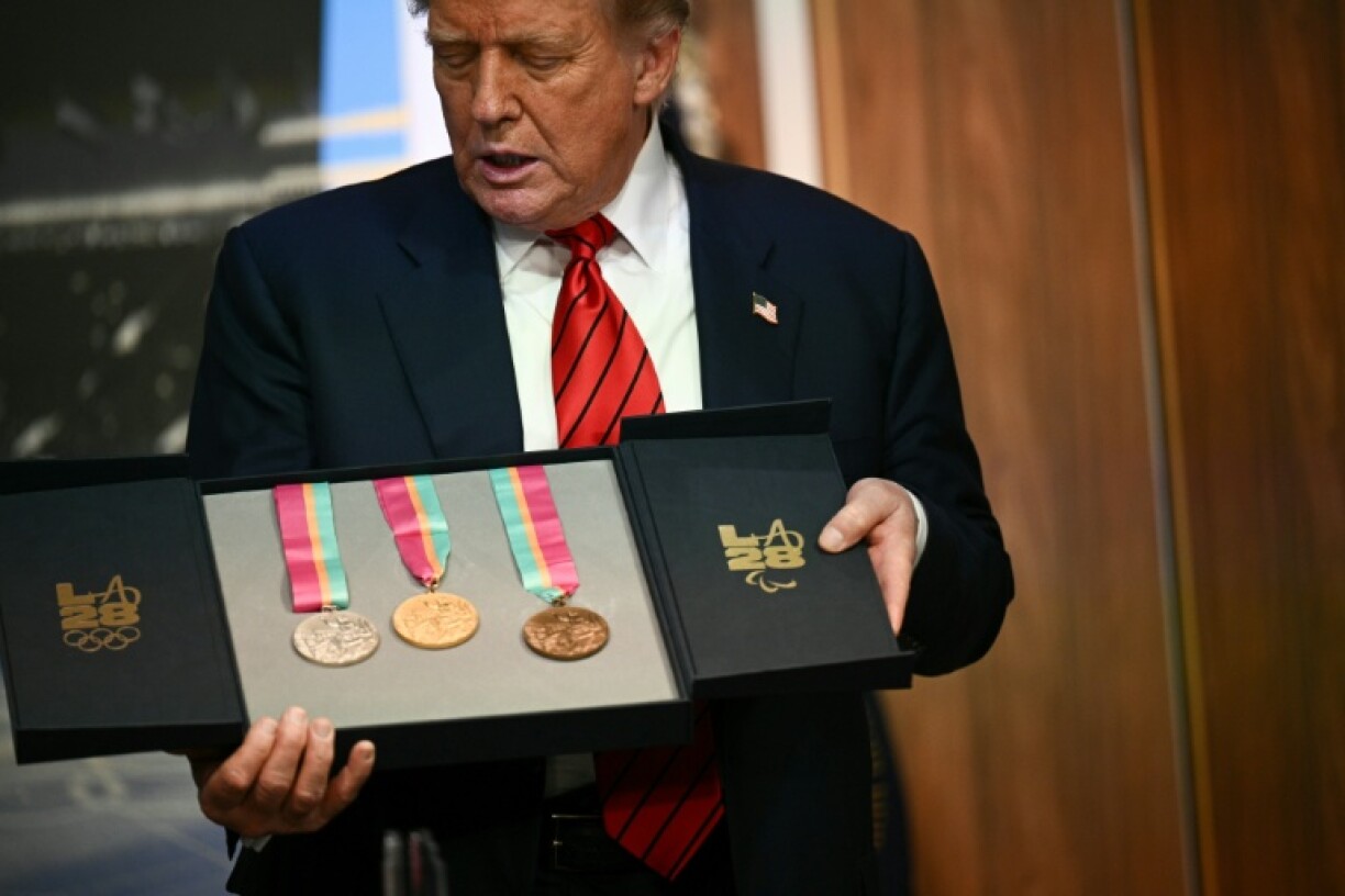 US President Donald Trump holds a box containing medals from the 1984 Los Angeles Olympics