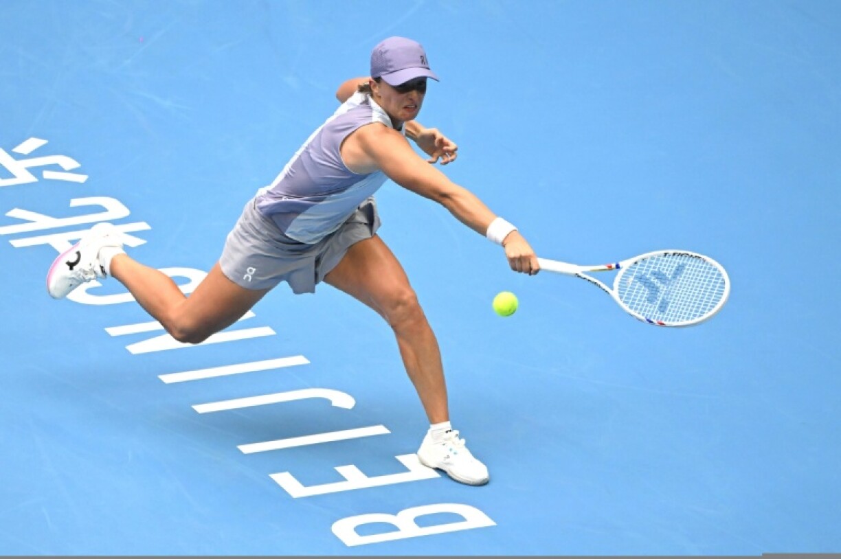 Poland’s Iga Swiatek hits a return to China’s Yuan Yue