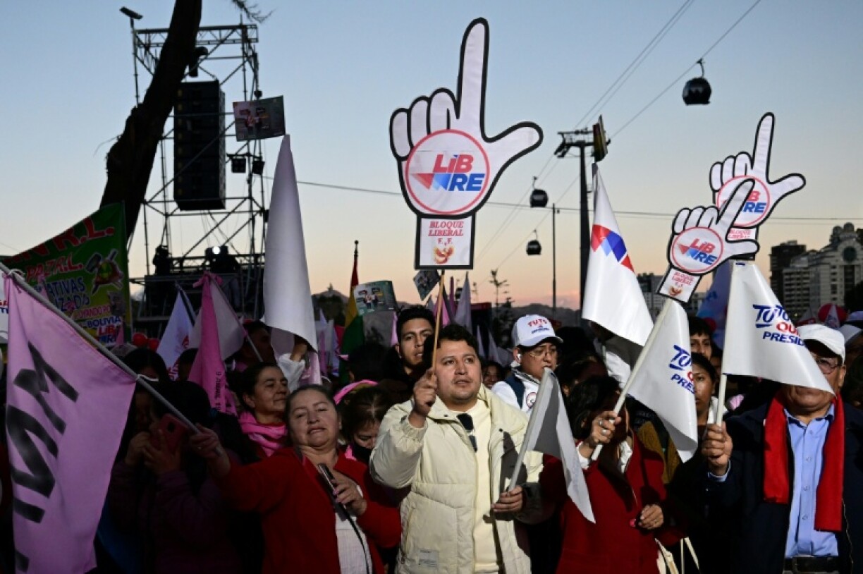 Supporters of Quiroga wave signs at the campaign rally