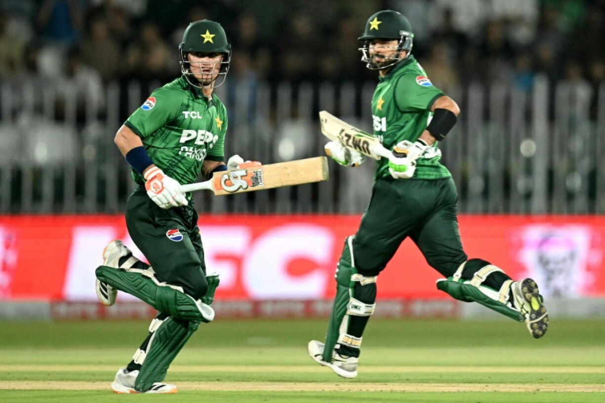 Pakistan captain Sahibzada Farhan (R) and Maaz Sadaqat run between the wickets during the second T20 international cricket match against Sri Lanka at Rawalpindi